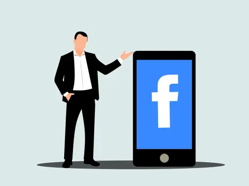 Mężczyzna w garniturze obok telefonu z logo Facebook. Dowiedz się, jak usunąć rolki z Facebooka.