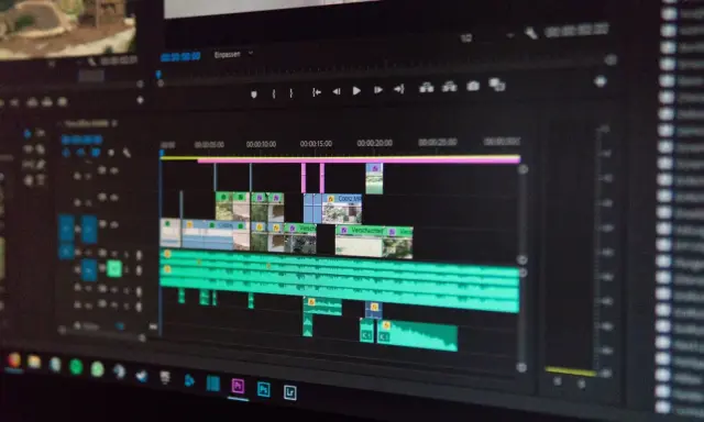 Ekran komputera z oprogramowaniem do montażu filmów. Widoczna oś czasu z klipami wideo i ścieżkami audio, gotowa do edycji.