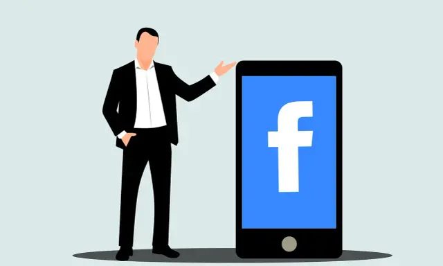 Mężczyzna w garniturze obok telefonu z logo Facebook. Dowiedz się, jak usunąć rolki z Facebooka.