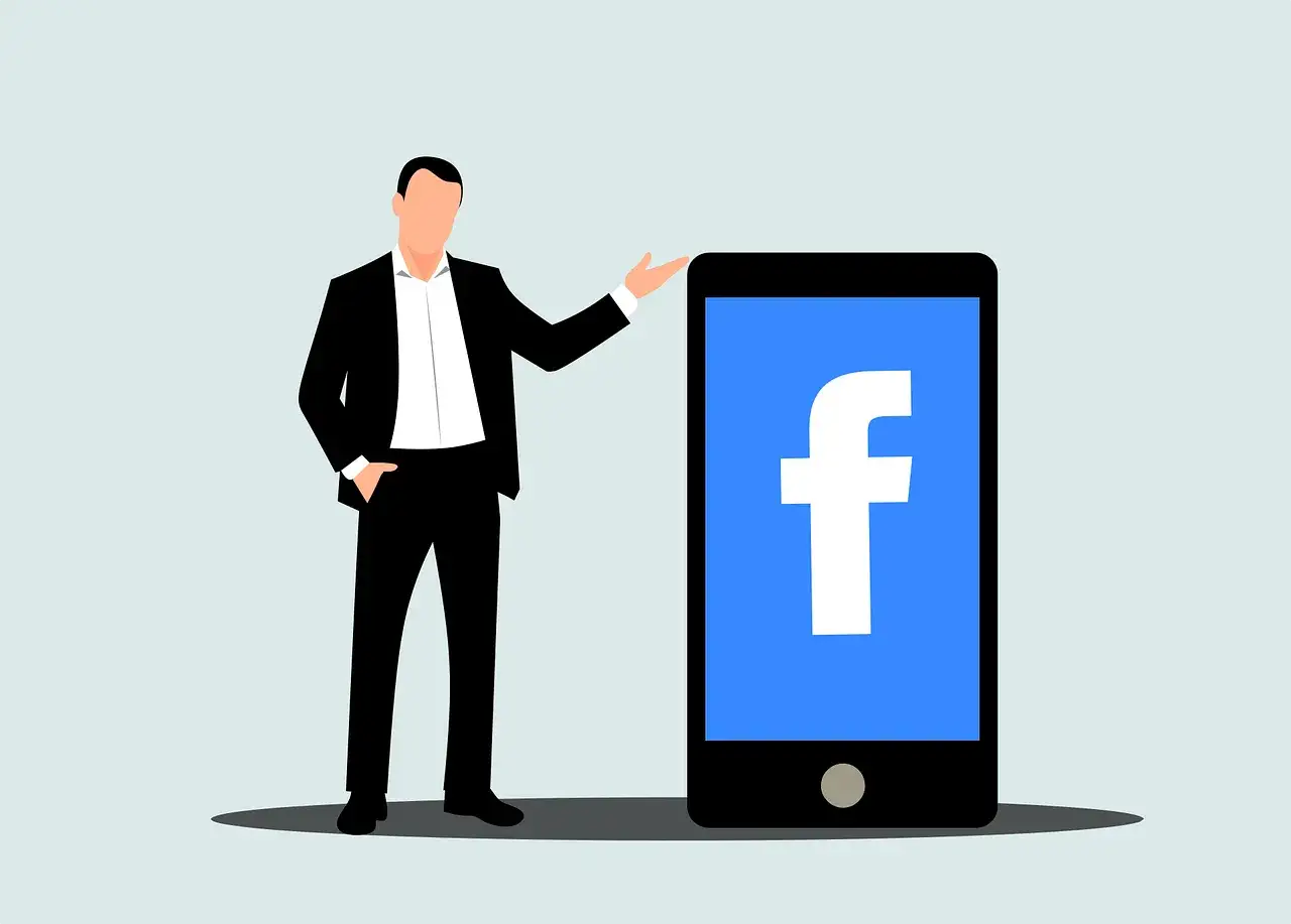 Mężczyzna w garniturze prezentuje smartfon z logo Facebooka. Dowiedz się, jak usunąć rolki z Facebooka, aby uporządkować swój profil.